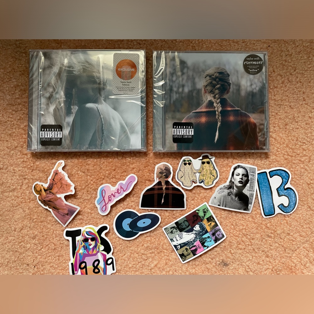 Folklore and Evermore CDs with stickers